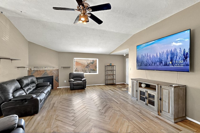 5401 Crown Ridge Rd NW, Albuquerque, NM 87114 - living room with light wood-type flooring, vaulted ceiling, a textured ceiling, a ceiling fan, and a fireplace