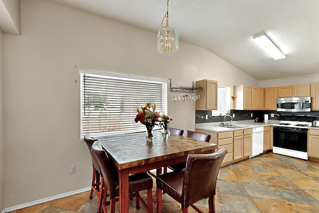 5401 Crown Ridge Rd NW, Albuquerque, NM 87114 - kitchen with range with gas cooktop, stainless steel microwave, light brown cabinets, lofted ceiling, and dishwasher