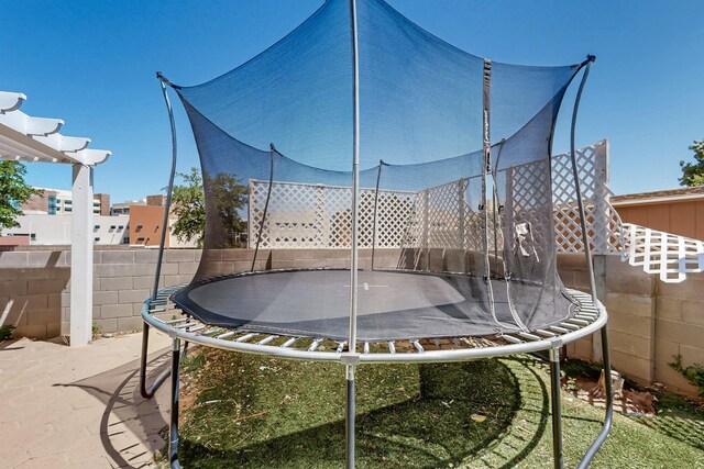 5401 Crown Ridge Rd NW, Albuquerque, NM 87114 - view of yard with a trampoline and fence