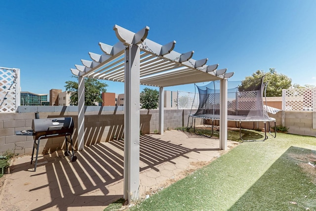 5401 Crown Ridge Rd NW, Albuquerque, NM 87114 - view of patio / terrace featuring a trampoline, a pergola, a fenced backyard, and grilling area