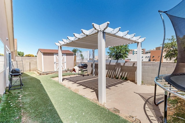 5401 Crown Ridge Rd NW, Albuquerque, NM 87114 - view of patio / terrace with a trampoline, a fenced backyard, a shed, a pergola, and an outdoor structure