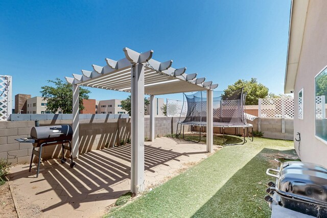 5401 Crown Ridge Rd NW, Albuquerque, NM 87114 - fenced backyard featuring a trampoline, a pergola, and a patio