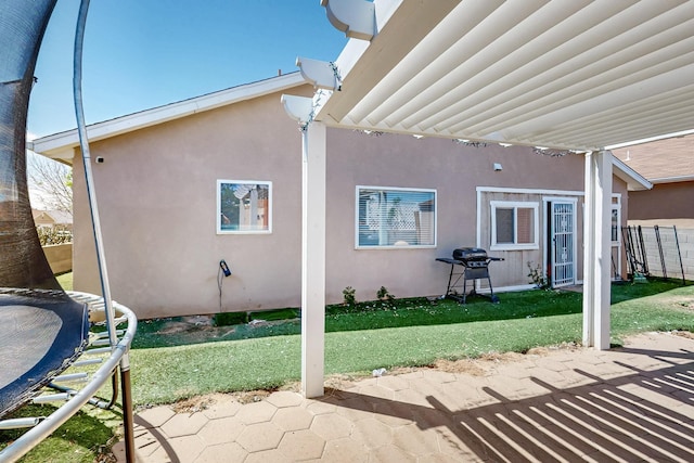 5401 Crown Ridge Rd NW, Albuquerque, NM 87114 - view of patio featuring a trampoline and area for grilling