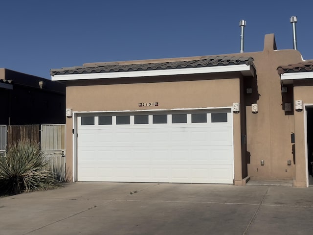 garage featuring concrete driveway