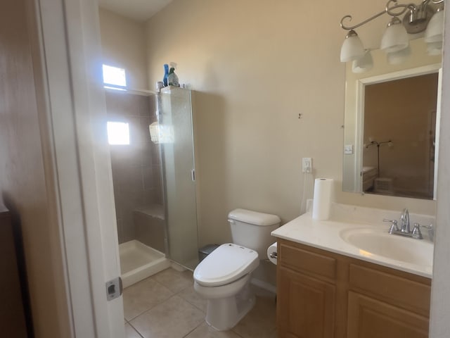 bathroom featuring vanity, tile patterned floors, a stall shower, and toilet