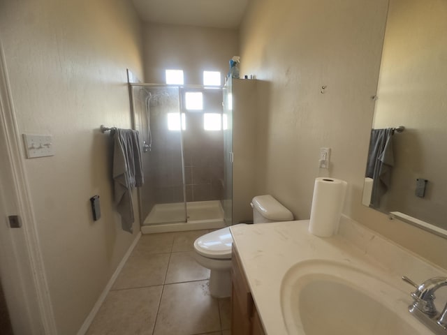 bathroom featuring vanity, tile patterned floors, a stall shower, and toilet