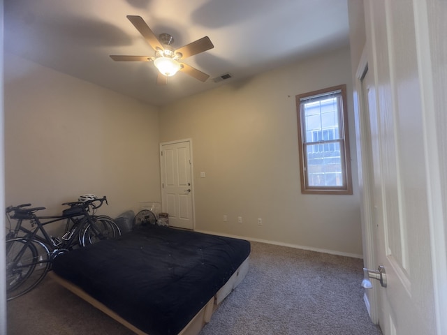 carpeted bedroom featuring baseboards, a ceiling fan, and visible vents