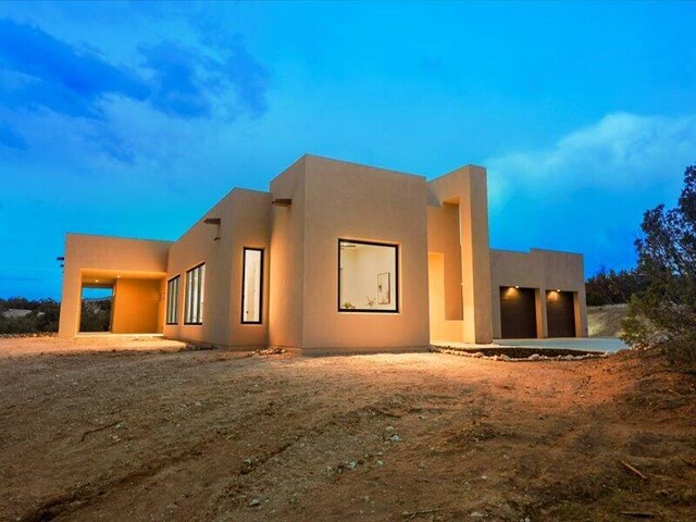 19 Anasazi Trl, Sandia Park, NM 87047 - rear view of property featuring an attached garage and stucco siding