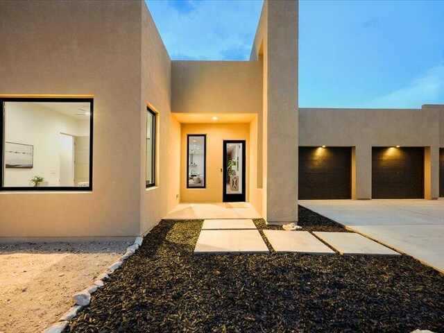 19 Anasazi Trl, Sandia Park, NM 87047 - exterior space featuring a garage, stucco siding, and driveway
