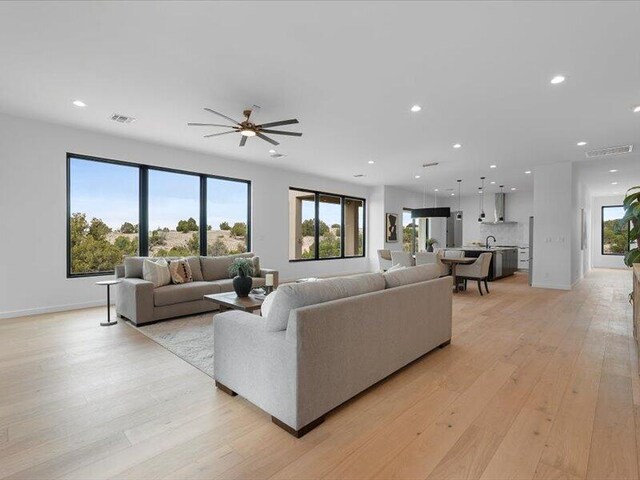 19 Anasazi Trl, Sandia Park, NM 87047 - living area featuring visible vents, ceiling fan, recessed lighting, light wood-type flooring, and a wealth of natural light