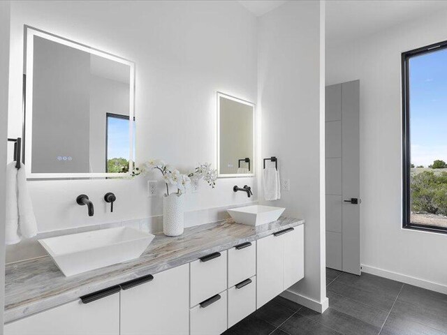 19 Anasazi Trl, Sandia Park, NM 87047 - bathroom featuring baseboards, a sink, tile patterned floors, and double vanity