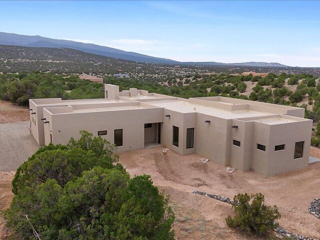 19 Anasazi Trl, Sandia Park, NM 87047 - view of front of house featuring a mountain view and stucco siding