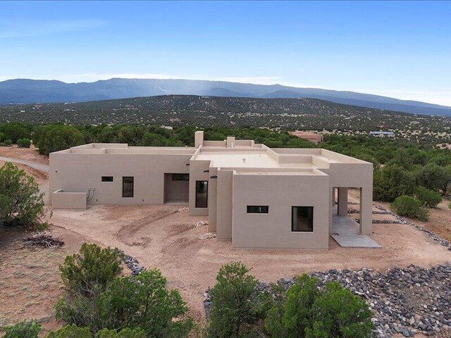 19 Anasazi Trl, Sandia Park, NM 87047 - rear view of house featuring a mountain view and stucco siding