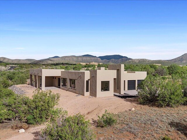 19 Anasazi Trl, Sandia Park, NM 87047 - back of house with a mountain view and stucco siding
