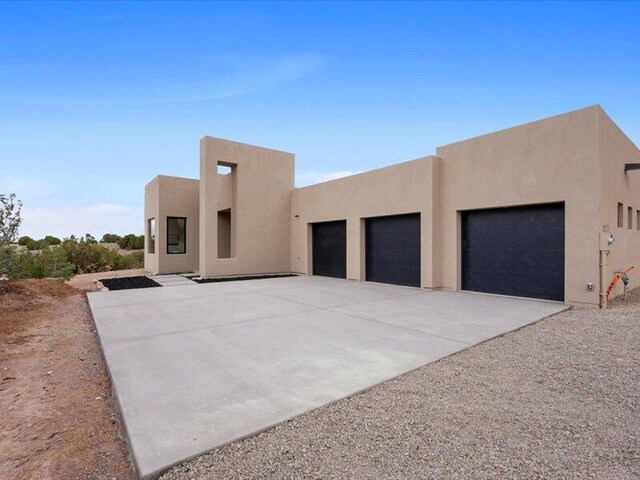 19 Anasazi Trl, Sandia Park, NM 87047 - pueblo-style house featuring stucco siding