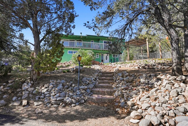 rear view of property featuring stairs