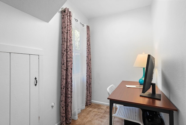 office featuring baseboards and light colored carpet