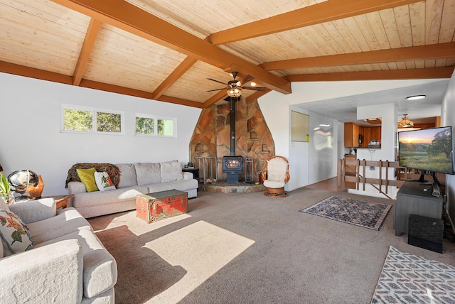 living room with a wood stove, ceiling fan, wooden ceiling, lofted ceiling with beams, and carpet