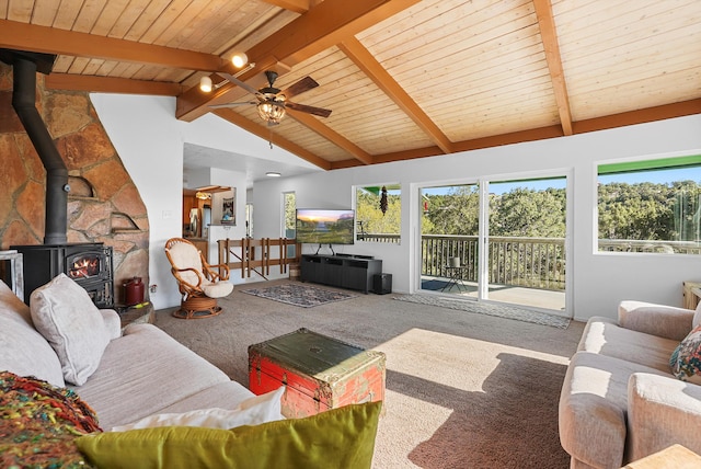 carpeted living area featuring wooden ceiling, ceiling fan, lofted ceiling with beams, and a wood stove