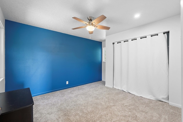 unfurnished room with carpet floors, ceiling fan, and baseboards