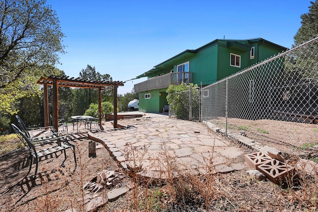 view of patio / terrace featuring a pergola and fence