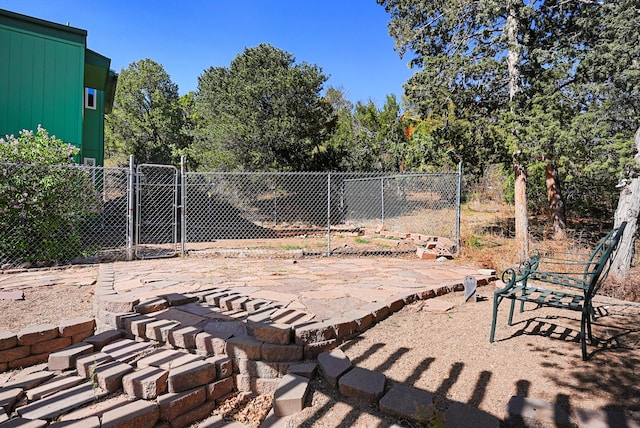 view of yard featuring a gate, a patio area, and fence