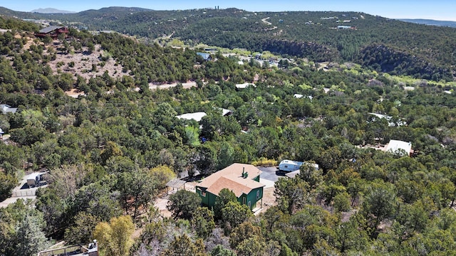 aerial view with a mountain view and a wooded view