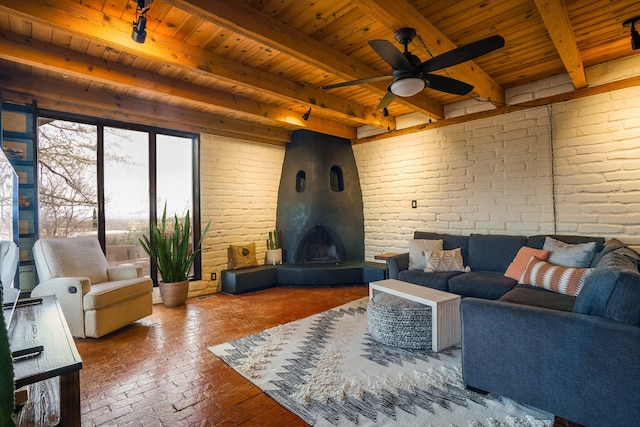 living area with wood ceiling and brick wall