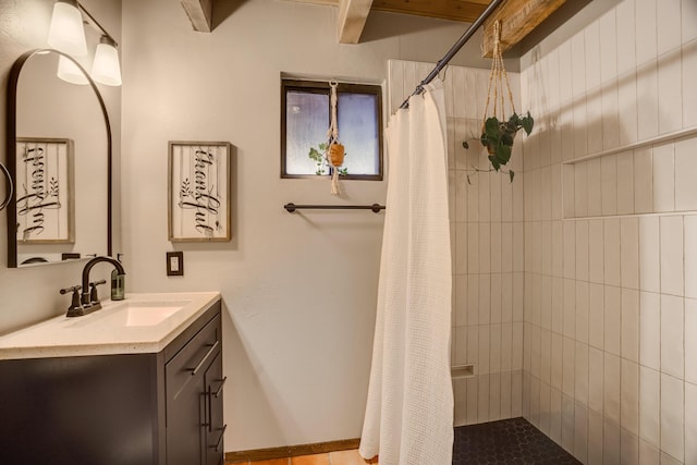 full bathroom with a tile shower and vanity