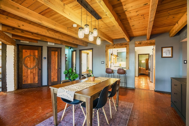 dining room with brick floor, wooden ceiling, and beamed ceiling