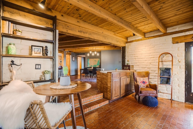 interior space featuring wood ceiling, brick floor, and beam ceiling