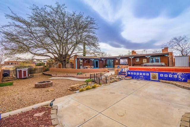 exterior space with a patio, a fire pit, and a fenced backyard