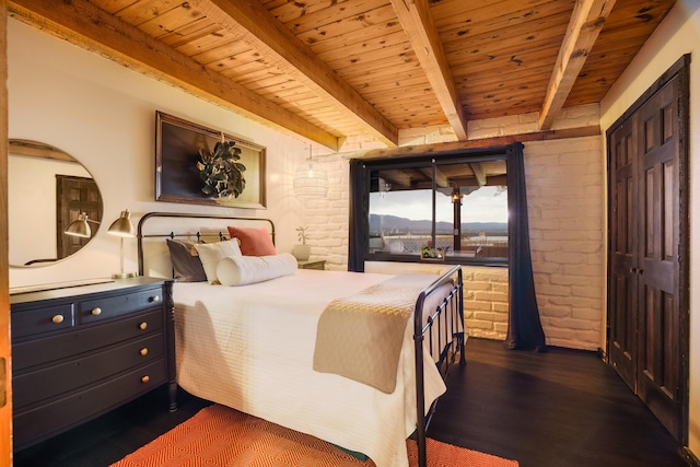 bedroom with brick wall, wooden ceiling, dark wood-style flooring, and beam ceiling
