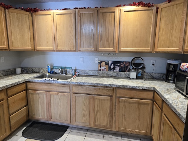 908 W Chavez Ave, Belen, NM 87002 - kitchen featuring a sink, light tile patterned floors, and light countertops