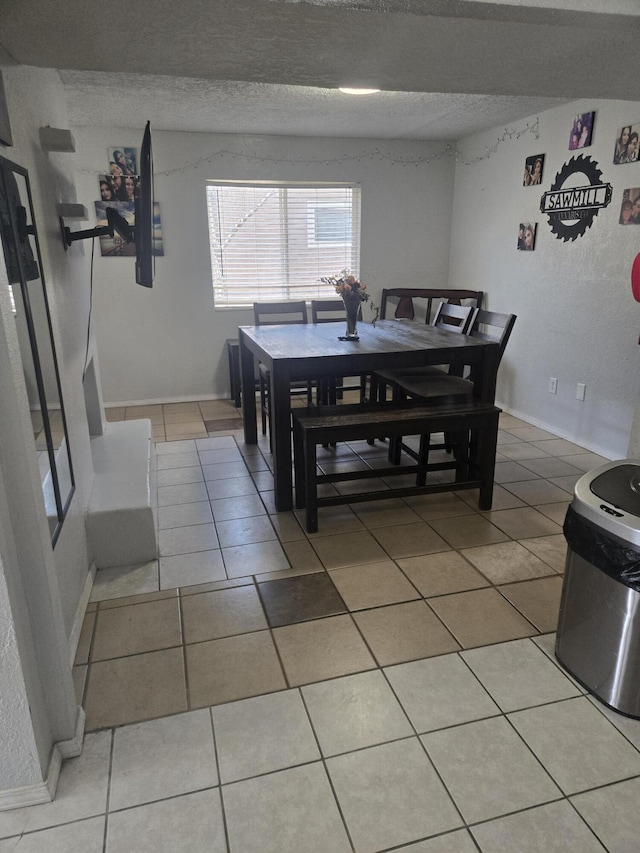 908 W Chavez Ave, Belen, NM 87002 - dining room with light tile patterned floors and a textured ceiling