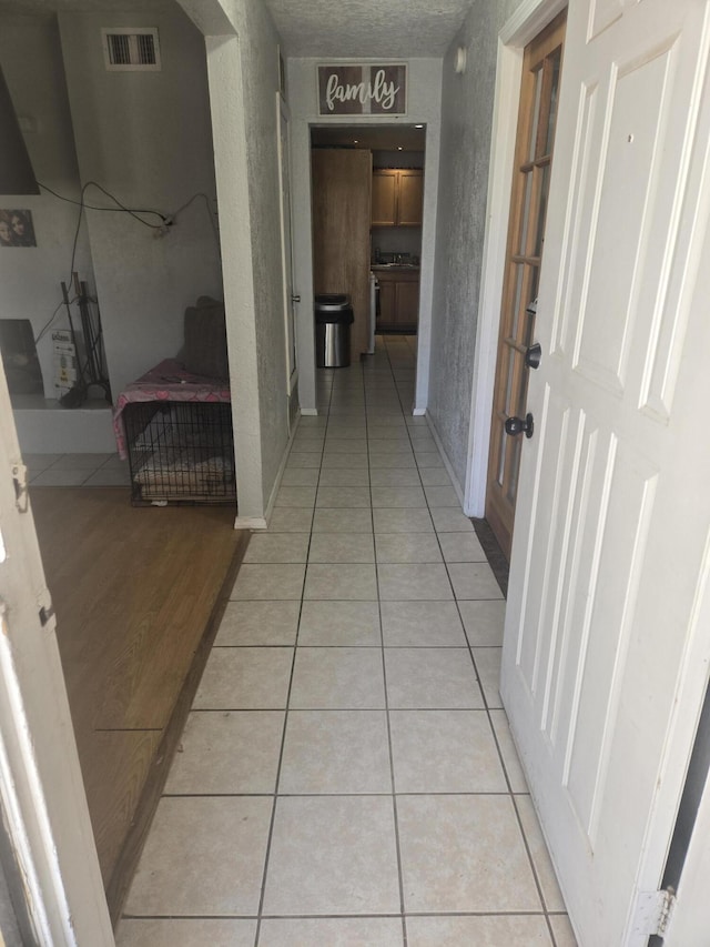 908 W Chavez Ave, Belen, NM 87002 - hall featuring visible vents and light tile patterned floors