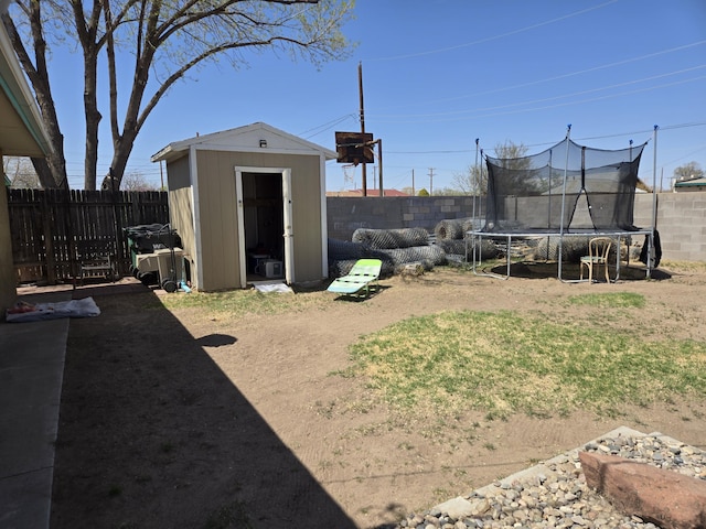 908 W Chavez Ave, Belen, NM 87002 - view of yard with a storage shed, a trampoline, an outdoor structure, and a fenced backyard
