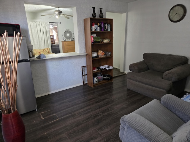 908 W Chavez Ave, Belen, NM 87002 - living room featuring baseboards, a ceiling fan, a textured wall, and wood finished floors