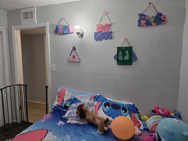 908 W Chavez Ave, Belen, NM 87002 - unfurnished bedroom with tile patterned flooring and visible vents
