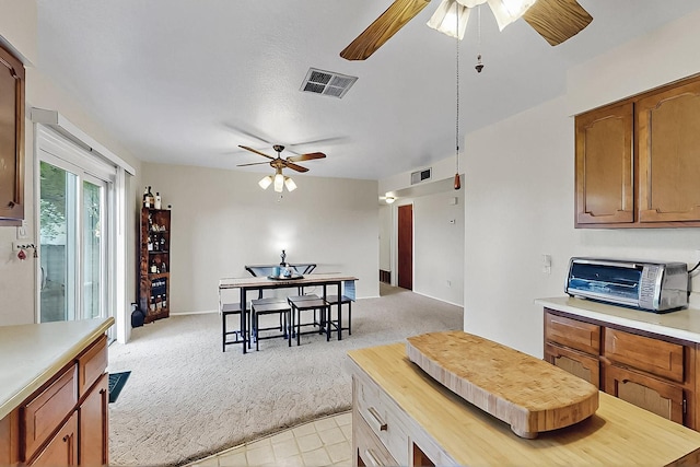 1513 Muriel St NE, Albuquerque, NM 87112 - kitchen with ceiling fan, light countertops, and light carpet