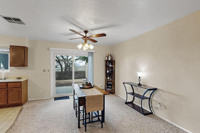 1513 Muriel St NE, Albuquerque, NM 87112 - dining room featuring a ceiling fan and light carpet