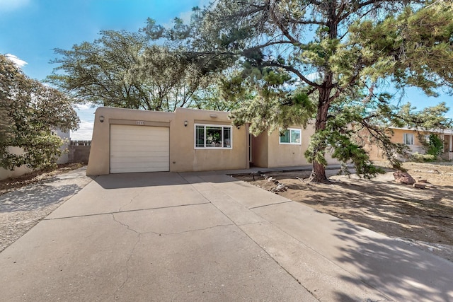 1513 Muriel St NE, Albuquerque, NM 87112 - southwest-style home with an attached garage, concrete driveway, and stucco siding
