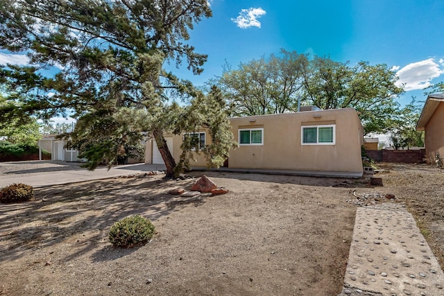 1513 Muriel St NE, Albuquerque, NM 87112 - view of front of property featuring stucco siding, concrete driveway, and a garage