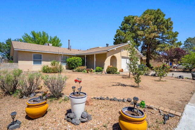 7225 Ticonderoga Rd NE, Albuquerque, NM 87109 - view of front of house featuring an attached garage and stucco siding