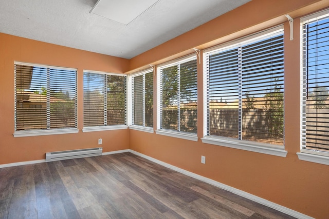 7225 Ticonderoga Rd NE, Albuquerque, NM 87109 - spare room with baseboards, baseboard heating, and wood finished floors