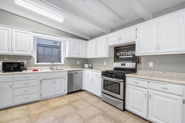 7225 Ticonderoga Rd NE, Albuquerque, NM 87109 - kitchen featuring white cabinetry, a sink, appliances with stainless steel finishes, and vaulted ceiling with beams