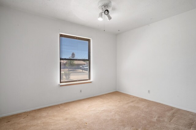 7225 Ticonderoga Rd NE, Albuquerque, NM 87109 - spare room with ceiling fan, light carpet, and baseboards