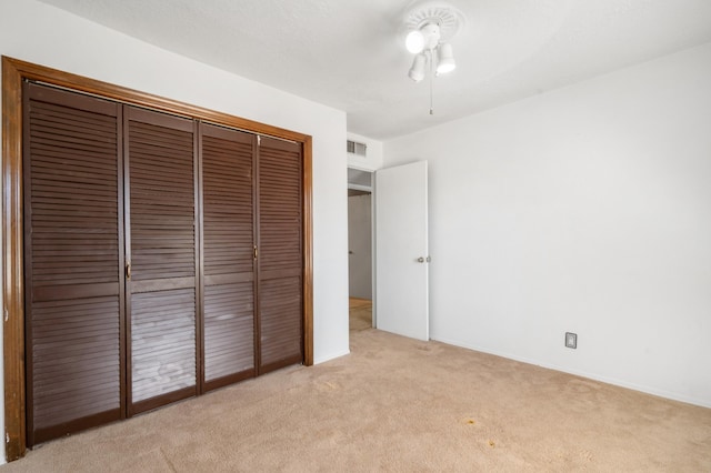 7225 Ticonderoga Rd NE, Albuquerque, NM 87109 - unfurnished bedroom featuring ceiling fan, visible vents, light colored carpet, baseboards, and a closet