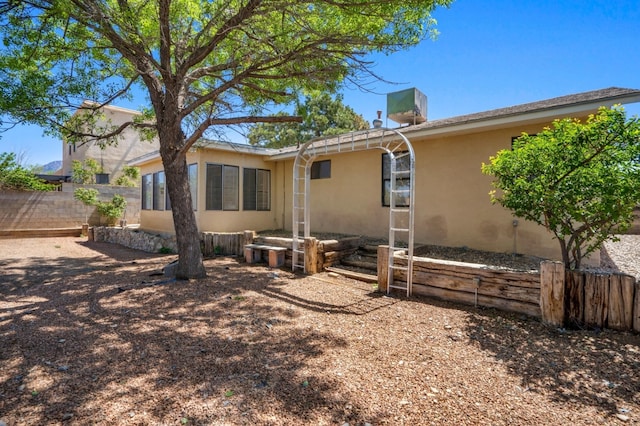 7225 Ticonderoga Rd NE, Albuquerque, NM 87109 - rear view of house with stucco siding