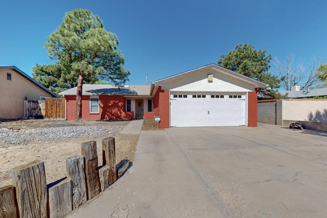6625 Barnhart St NE, Albuquerque, NM 87109 - single story home with brick siding, an attached garage, fence, and concrete driveway